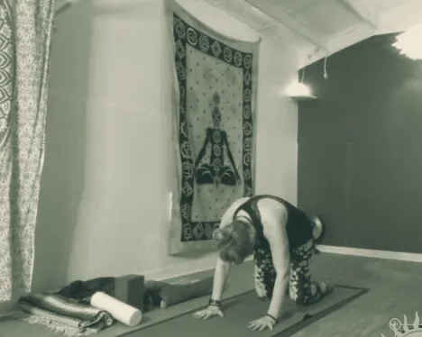 The Chattanooga Yoga Center studio, with a chakra tapestry, props and a calm blue wall