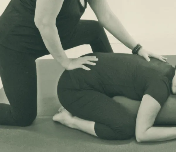 Cheryl giving a student gentle hands-on Thai yoga bodywork